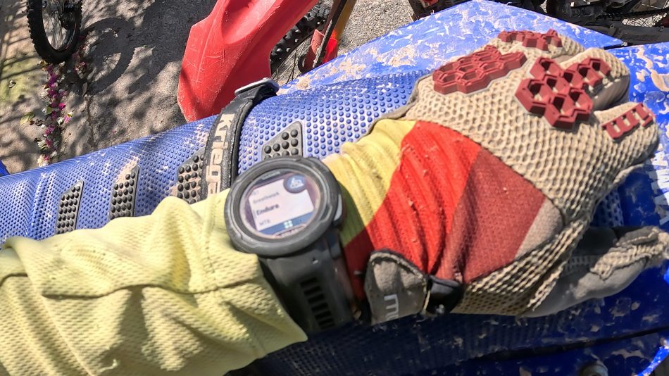 garmin instinct 2s solar on wrist of off-road motorcycle rider